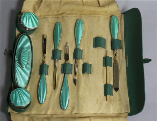 An eight piece (ex 11) silver and enamel mounted manicure set, Albert Carter, Birmingham, 1935, in Asprey leather carrying pouch.